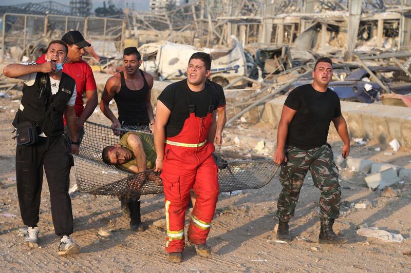 An injured man is taken from the scene of explosion at the Beirut port.  EPA