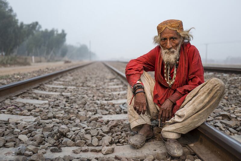 Photograph of a Sufi mystic sitting on a railway track in Sahiwal, Pakistan, by Sohail Karmani. Courtesy Sohail Karmani 