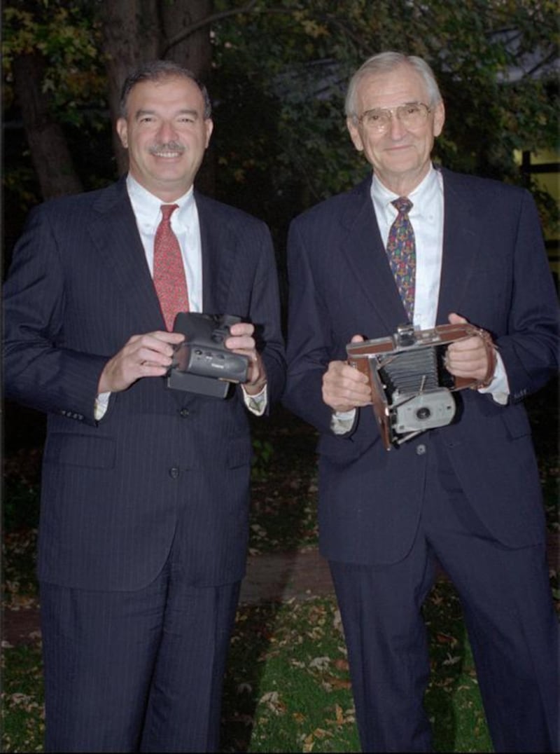 Gary DiCamillo, left, the chief executive of Polaroid from 1995 through 2002, guided the company through its first restructuring. He took over from I MacAllister Booth, right. CJ Gunther / AP Photo