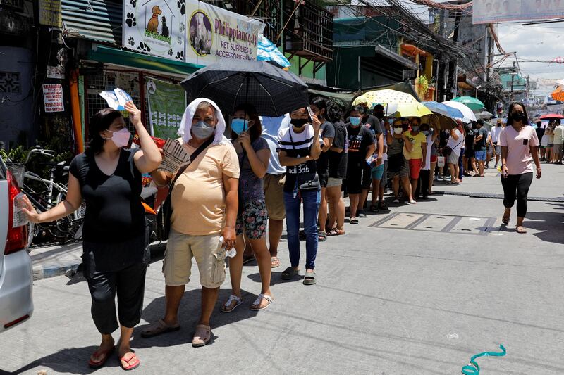 People queue to vote at a polling station in Tondo, Metro Manila. Reuters