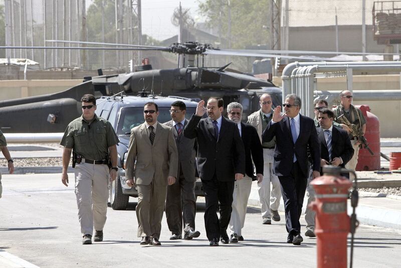 Nouri Al Maliki, centre, and Zalmay Khalilzad, right, then US ambassador to Iraq, arrive at the new Baghdad South power plant on  June 2, 2006.
