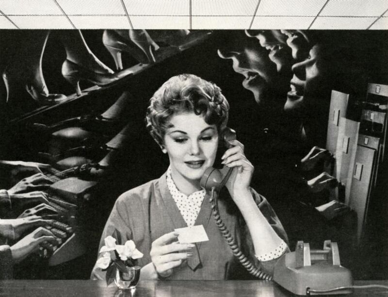 Woman On Phone In Noisy Office. Getty Images