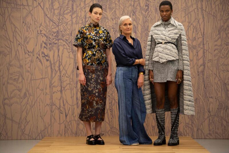 Christian Dior's creative director Maria Grazia Chiuri, centre, poses with models during a preview of the maison's haute couture collection at the Dior headquarters in Paris on July 3, 2021.