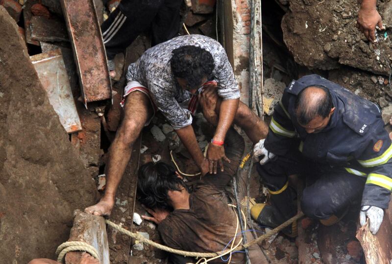 Rescue workers pull out a victim from the rubble. Reuters