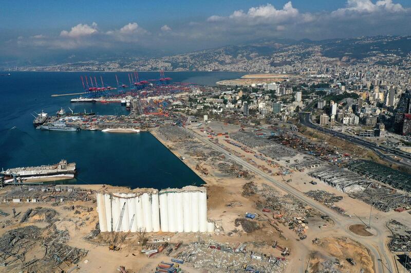 TOPSHOT - An aerial view taken on August 26, 2020, shows the port of Beirut with the grain silo in the foreground and surrounding neighbourhoods, devastated in the August 4 massive explosion that caused severe damage across swathes of the Lebanese capital, killed at least 181 people, injured more than 6,500 and left scores of people homeless. / AFP / -
