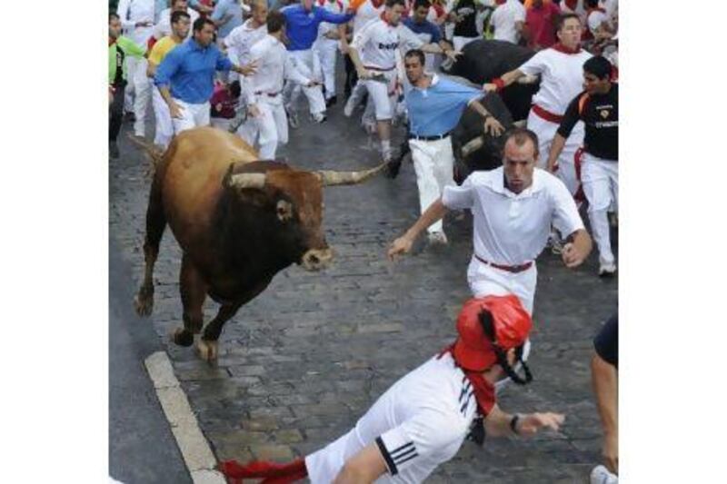 One runner was gored in the leg and three more needed hospital treatment after last July's running of the bulls in Pamplona. Vincent West / Reuters