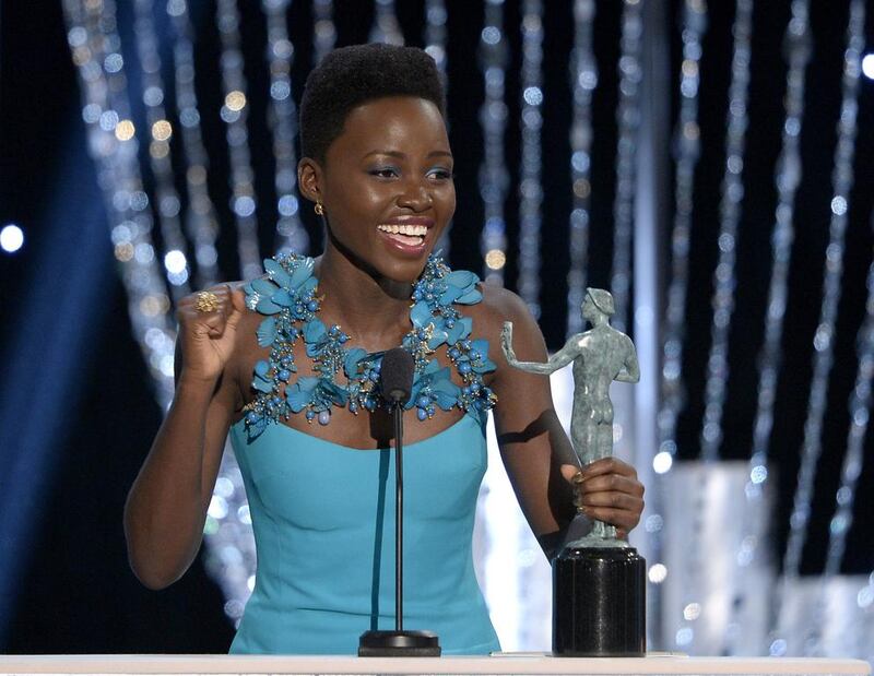 Actress Lupita Nyong'o accepts the Outstanding Performance by a Female Actor in a Supporting Role award for 12 Years a Slave. AFP 