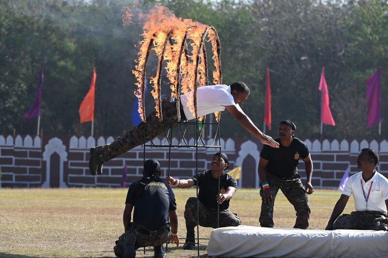 RPF members jump through a ring of fire. AFP