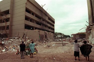 This August 1998 file picture shows Kenyan residents looking at the US embassy days after the bomb blast on August 7, 1998. AFP, file  