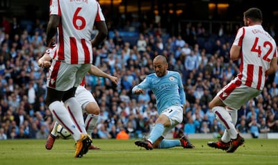 Soccer Football - Premier League - Manchester City vs Stoke City - Etihad Stadium, Manchester, Britain - October 14, 2017   Manchester City's David Silva scores their third goal    REUTERS/Andrew Yates    EDITORIAL USE ONLY. No use with unauthorized audio, video, data, fixture lists, club/league logos or "live" services. Online in-match use limited to 75 images, no video emulation. No use in betting, games or single club/league/player publications. Please contact your account representative for further details.