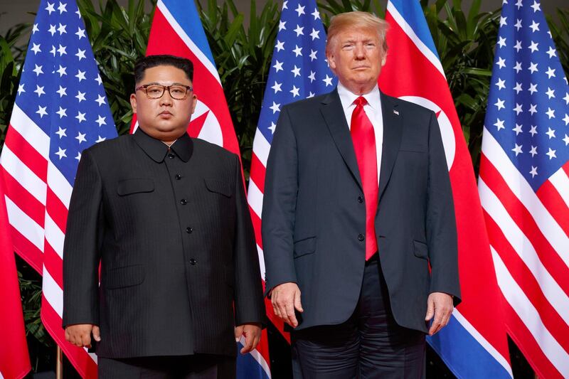FILE - In this June 12, 2018, file photo, U.S. President Donald Trump, right, stands with North Korean leader Kim Jong Un on Sentosa Island in Singapore. North Korea and the United States are trying to revive stalled diplomacy meant to rid the North of its nuclear weapons. There was much talk of the possibility of success following a meeting in June between Trump and Kim, but in the months since there has been little to quiet skeptics who believe the North will never give up weapons it has described as necessary to counter a hostile Washington. (AP Photo/Evan Vucci, File)