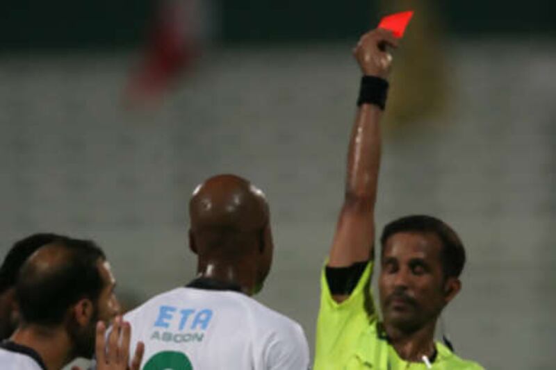 Al Shabab's Marcos Assuncao is shown a red card.