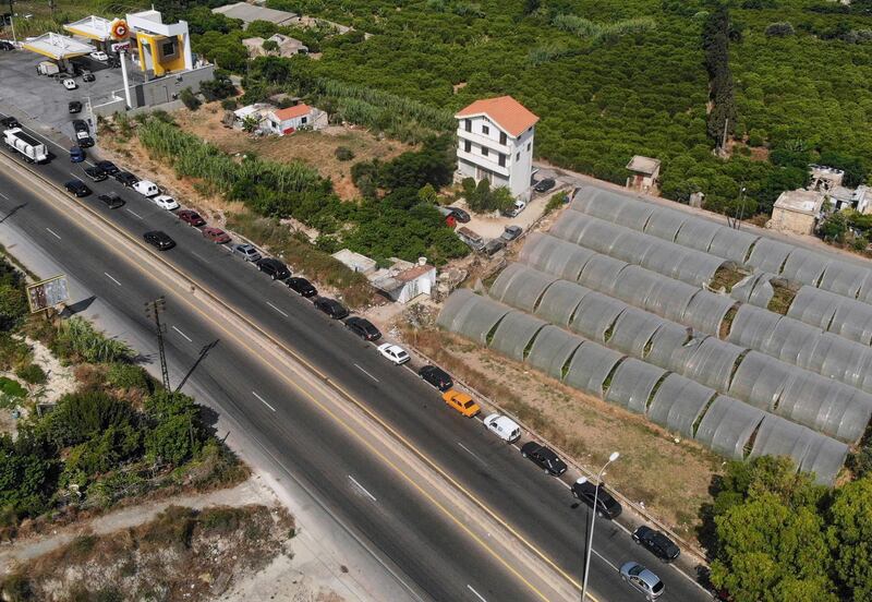 Drivers queue for fuel as traffic flows past on the Tripoli-Beirut motorway in the coastal city of Batroun. The head of Hezbollah, Lebanon's powerful Shiite movement on June 8 said that the country could soon be forced to rely on fuel imports from Iran. AFP