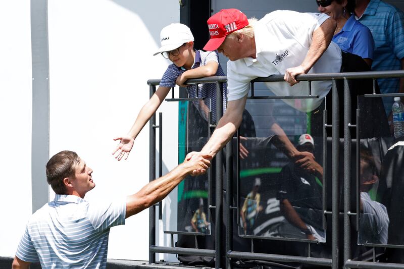 Bryson DeChambeau shakes hands with Mr Trump. Photo: USA TODAY Sports