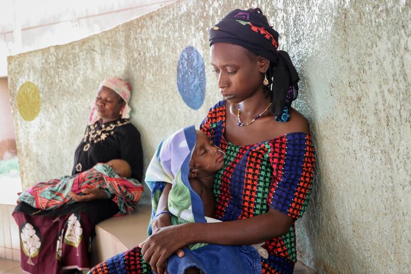 Fatima Li, 20, foreground, holds her two-year-old son, Hama Sow, as he is treated with a feeding tube for malnourishment, as Hadiara Ouedraogo, left, sits with her granddaughter, Fatimata Ouedrago, 2, who has edema due to severe malnourishment, at Yalgado Ouedraogo University in Ouagadougou, Burkina Faso on Monday, June 22, 2020. In Burkina Faso one in five young children is chronically malnourished. Food prices have spiked, and 12 million of the countryâ€™s 20 million residents donâ€™t get enough to eat. (AP Photo/Sam Mednick)