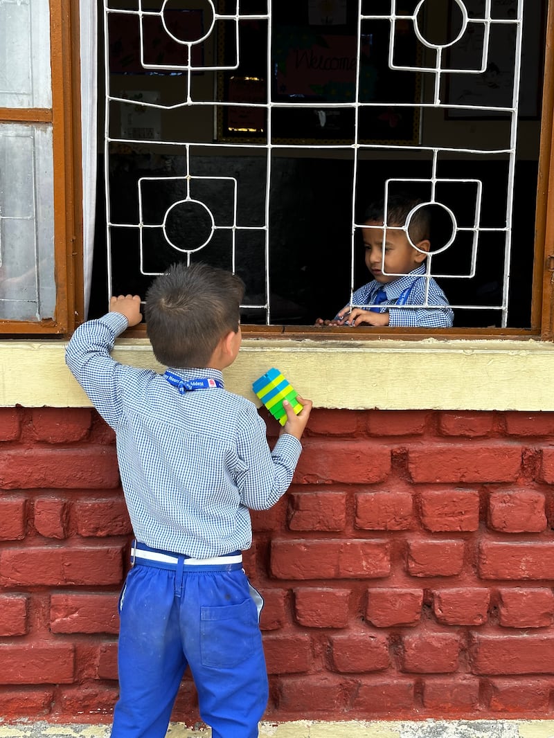 Two boys enjoy break time at the school, which caters for children from nursery age to 10th grade