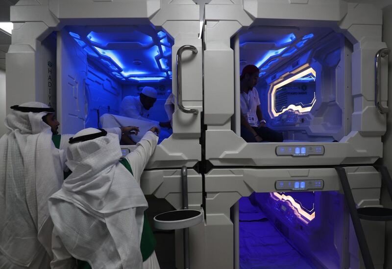 Saudi men are pictured inside sleep pods in Mecca on August 16, 2018. - The free nap pods are part of new measures Saudi Arabia is rolling out this year in a bid to modernise the centuries-old practice of hajj. (Photo by AHMAD AL-RUBAYE / AFP)