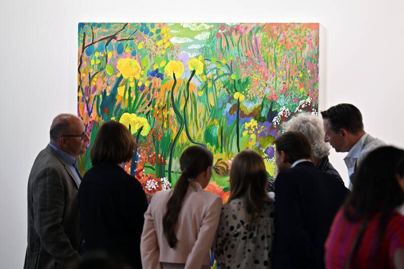 Visitors examine Shara Hughes's Some Flowers Get Trampled. Photo: Getty Images