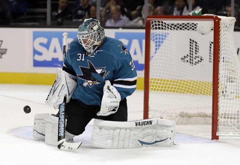 San Jose Sharks goalie Antti Niemi, of Finland, stops a shot by the Vancouver Canucks during the second period of a National Hockey League hockey game on Thursday. Goaltenders could have a harder time on their hands this season as the NHL takes steps to increase scoring. Marcio Jose Sanchez / AP Photo