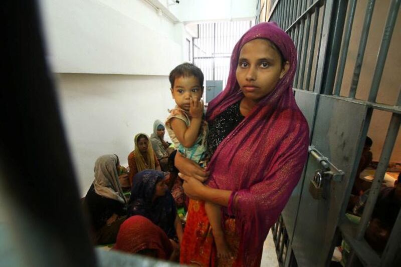 A Rohingya woman and her baby are seen detained in a police station after a fishing boat carrying more than sixty Rohingya refugees was found beached at Rawi island, part of Tarutao national park in the province of Satun, Thailand, bordering with Malaysia, June 12, 2019. REUTERS/Surapan Boonthanom