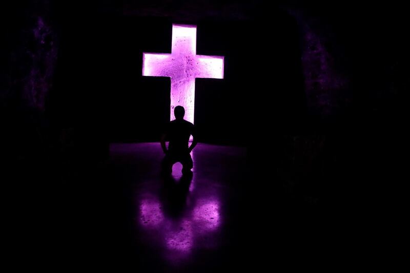 A man visits the Salt Cathedral in Zipaquira, Colombia, illuminated in pink in honor of Colombian cyclist Egan Bernal, who won the Giro d'Italia race. EPA
