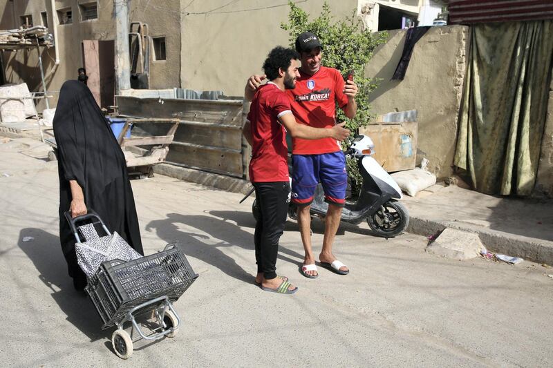 Iraqi footballer Hussein Ali, who plays for the Iraqi Al-Zawraa FC and is a lookalike of Liverpool's Egyptian forward Mohamed Salah, poses for pictures in the capital Baghdad, on June 4, 2018. - With his black beard, curly hair and football shirt, Iraqi striker Hussein Ali is often mistaken for one of the world's top players: Egypt's Mohamed Salah. (Photo by SABAH ARAR / AFP)