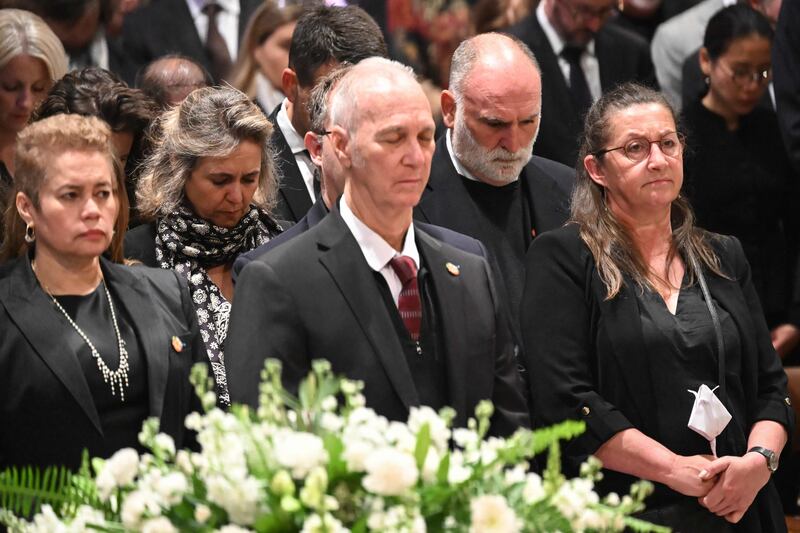 Jose Andres, second from right, bows his head during the interfaith service