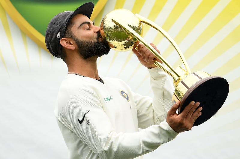 epa07266927 Indian captain Virat Kohli kisses the Border-Gavaskar Trophy as his team celebrates a 2-1 series victory over Australia following play being abandoned in the Fourth Test match between Australia and India at the SCG in Sydney, Australia, 07 January 2019.  EPA/DAN HIMBRECHTS NO ARCHIVING, EDITORIAL USE ONLY, IMAGES TO BE USED FOR NEWS REPORTING PURPOSES ONLY, NO COMMERCIAL USE WHATSOEVER, NO USE IN BOOKS WITHOUT PRIOR WRITTEN CONSENT FROM AAP AUSTRALIA AND NEW ZEALAND OUT