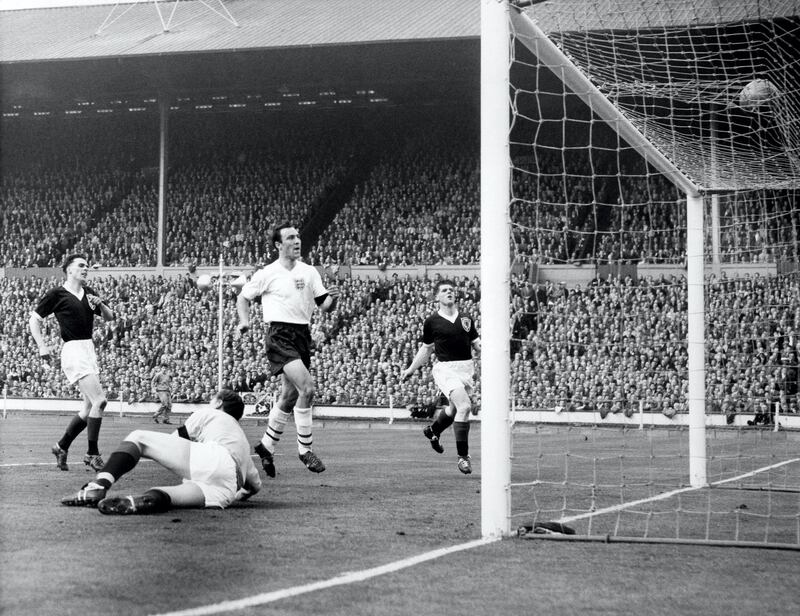 England's Jimmy Greaves (second r) scores his team's third goal past Scotland goalkeeper Frank Haffey (second l), watched by Scotland's Bobby Shearer (r) and Robert McCann (l)  (Photo by S&G/PA Images via Getty Images)