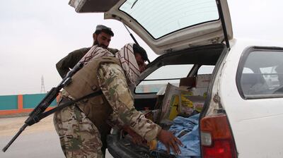 epa09136972 Afghan security officials check people at a roadside checkpoint in Helmand, Afghanistan, 15 April 2021. The United States will began removing its remaining troops from Afghanistan on 01 May and the withdrawal is to be complete by September 11, the 20th anniversary of the terrorist attacks on New York and Washington that spurred the invasion, US President Joe Biden said on 14 April 2021.  EPA/WATAN YAR