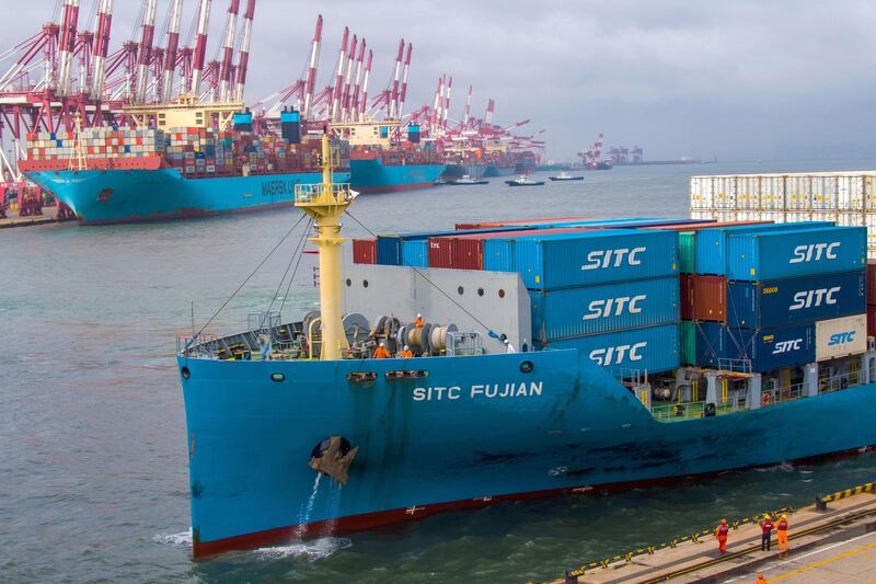 This photo taken on May 17, 2019 shows a container ship berthing at the port in Qingdao, in China's eastern Shandong province.  EU firms are "caught in the crossfire" of the US-China trade war, which is hurting the economic environment and exports to the United States, the European Union Chamber of Commerce in China said on May 20, 2019.  AFP PHOTO / China OUT - China OUT
 / AFP / STR
