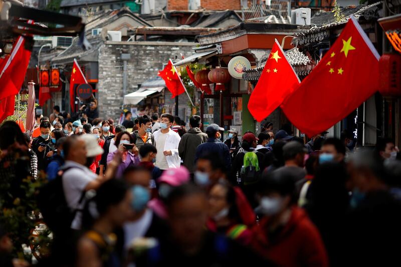 People walk in the tourist area surrounding Houhai Lake during Chinese National Day holidays in Beijing, China. Reuters