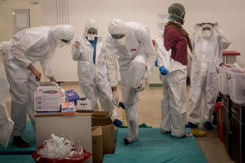 Medical staff get dressed in personal protective equipment before assisting Covid-19 patients in the Kartal Dr Lutii Kirdar Education and Research Hospital, Intensive Care Unit. Getty Images/AFP