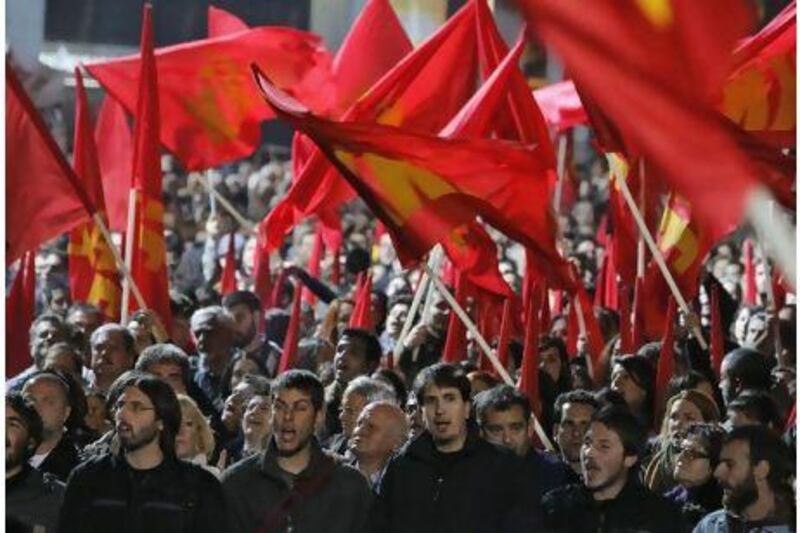 Greek Communist Party's members shout slogans during a protest in Athens Friday. Greece's ruling Socialists were in open revolt against their own prime minister ahead of a confidence vote.