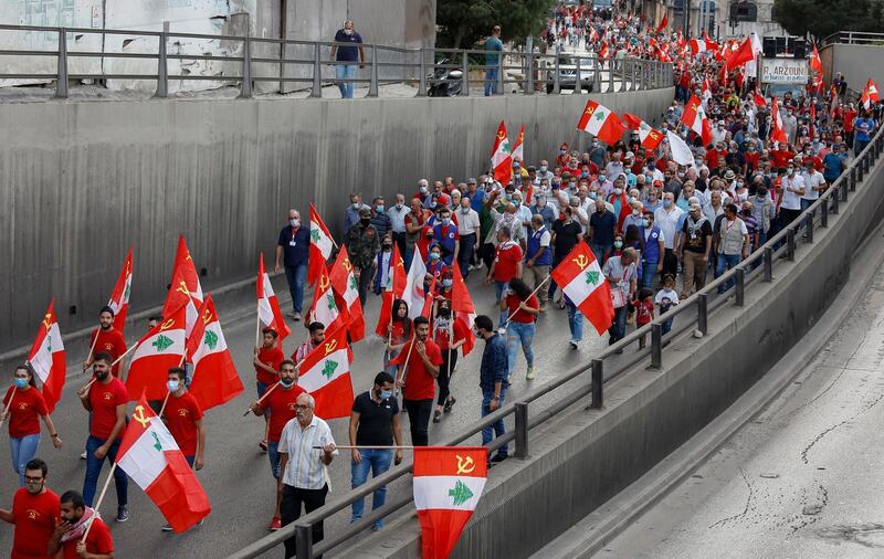 Supporters of the Lebanese Communist Party wave their party's flags as they march during a political festival to mark the 96th anniversary of the founding of the Lebanese Communist Party, in central Beirut. EPA