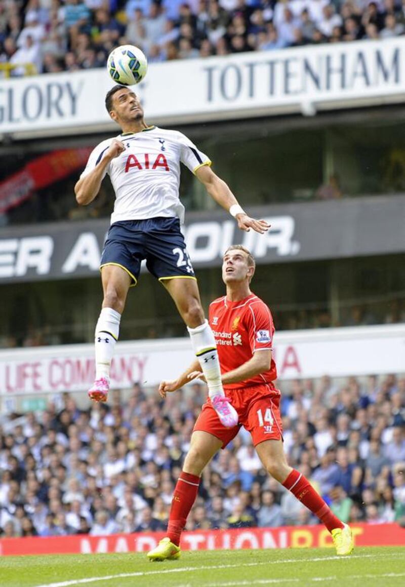 Tottenham Hotspur's Nacer Chadli vies for the ball with Liverpool's Jordan Henderson during their Premier League match on Sunday. Gerry Penny / EPA