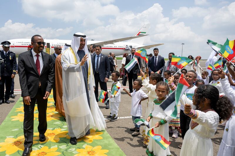 President Sheikh Mohamed greets local children during the official reception at the airport