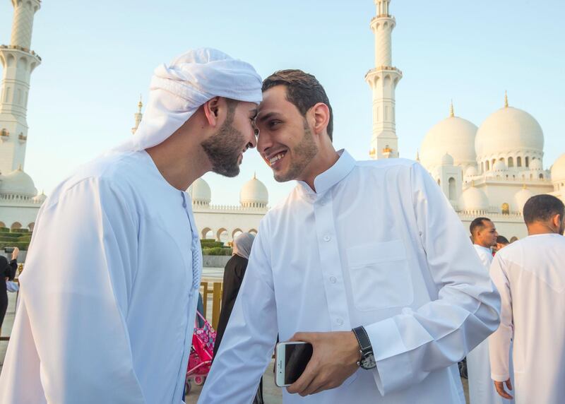 Abu Dhabi, UNITED ARAB EMIRATES - Faithfuls are greeting each other after performing morning prayers on the first day of Eid-Al Fitr at the Sheikh Zayed Grand Mosque.  Leslie Pableo for The National