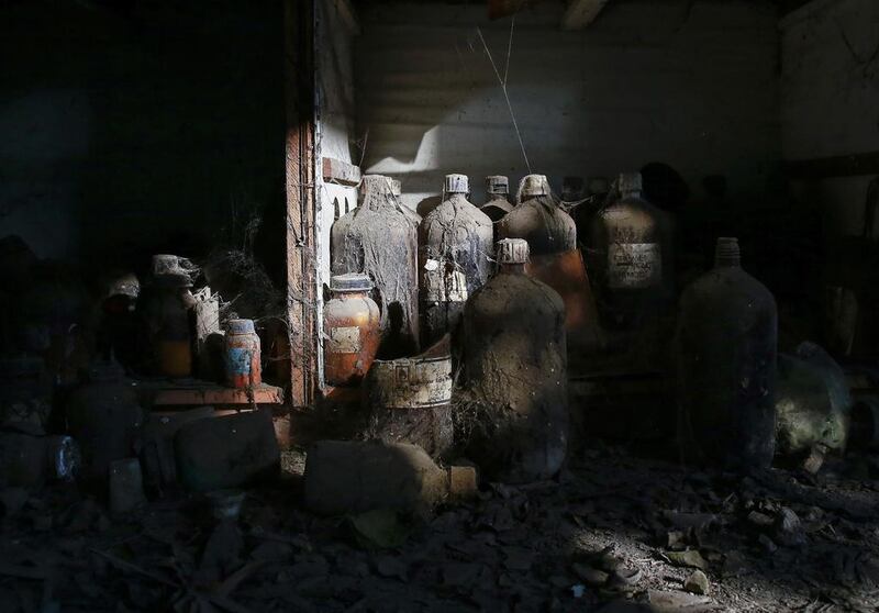 Thick dust covers chemical bottles in a laboratory at the abandoned former Union Carbide pesticide plant in Bhopal.