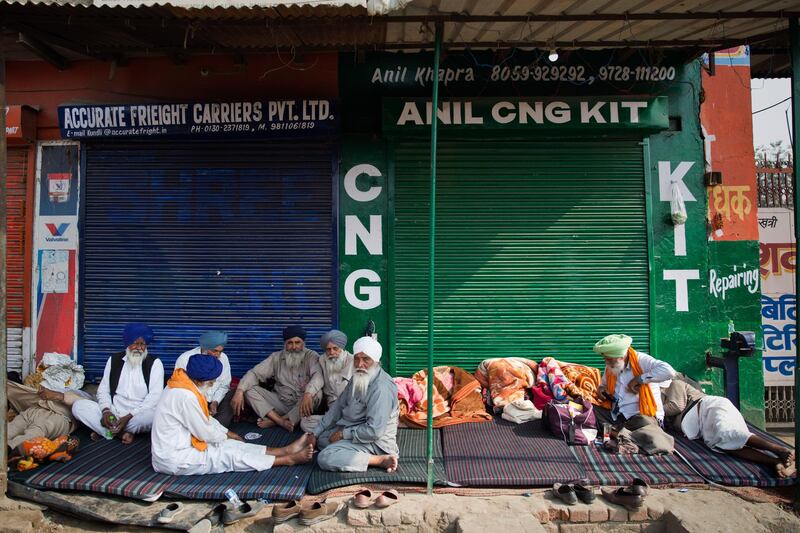 Protesting farmers eat a meal at the border between Delhi and Haryana state. Talks between protesting farmers and the Indian government failed Tuesday after both the parties could not reach a common ground.  AP
