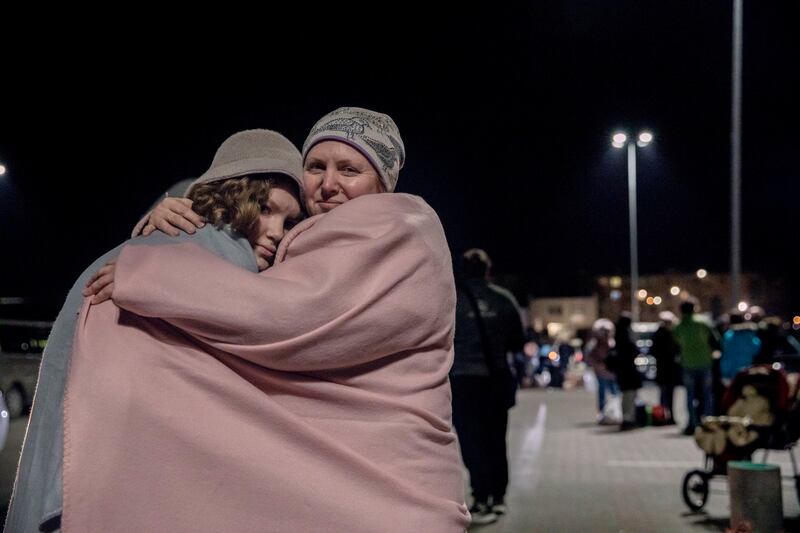 Ira, 45, and her daughter Olena, 12, outside a transit centre in Przemysl, Poland. Photo: Adrienne Surprenant