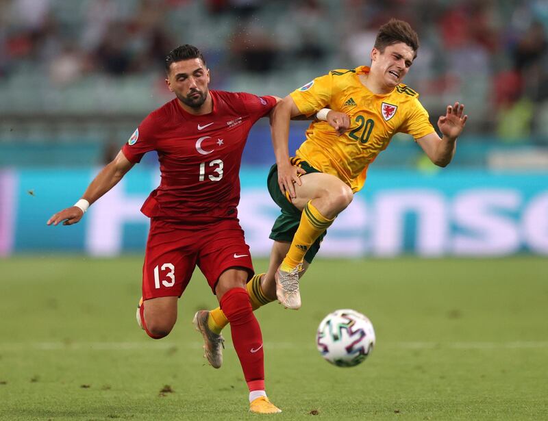 Turkey's Umut Meras challenges Daniel James of Wales. PA