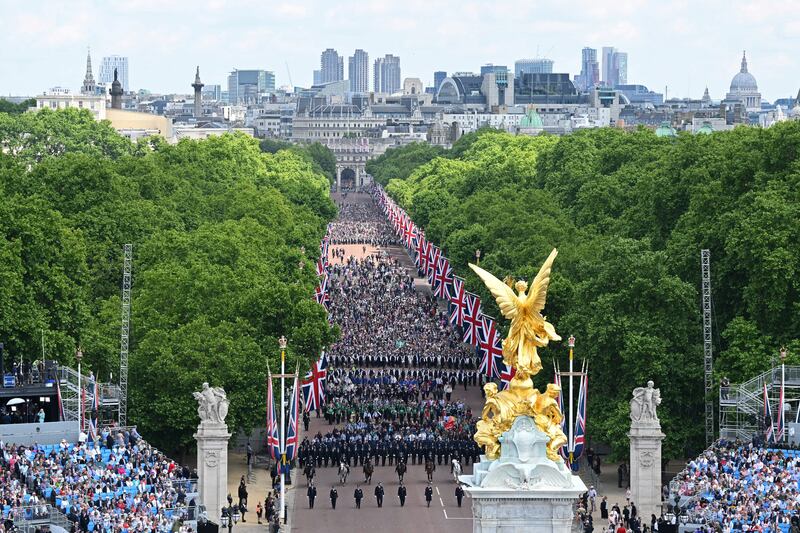 Members of the public fill The Mall ahead of a fly-past over Buckingham Palace during Trooping The Colour in London. Trooping The Colour, also known as The Queen's Birthday Parade, is a military ceremony performed by regiments of the British Army that has taken place since the mid-17th century. Getty Images