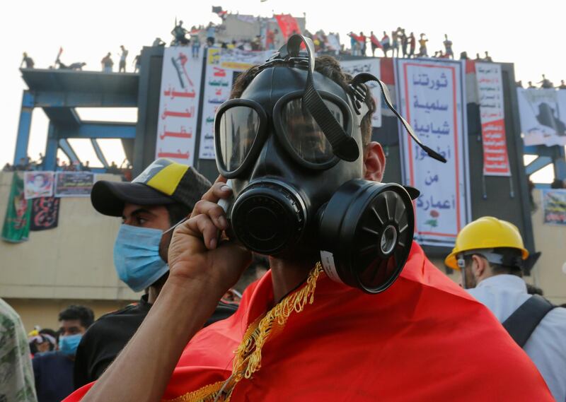 A demonstrator wears a mask to protect himself from tear gas. Reuters