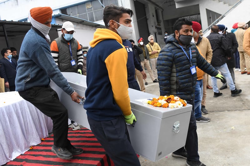 Workers carry the coffin of Hardev Singh.