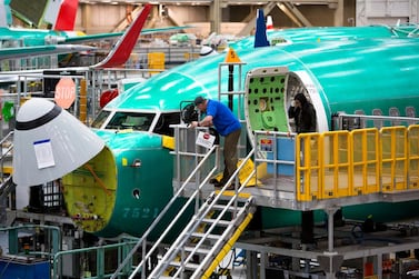 (FILES) In this file photo taken on March 27, 2019 Employees work on Boeing 737 MAX airplanes at the Boeing Renton Factory in Renton, Washington. Boeing could on Monday announce whether to further cut or suspend production of its grounded 737 MAX plane, The Wall Street Journal reported December 15, 2019. / AFP / Jason Redmond