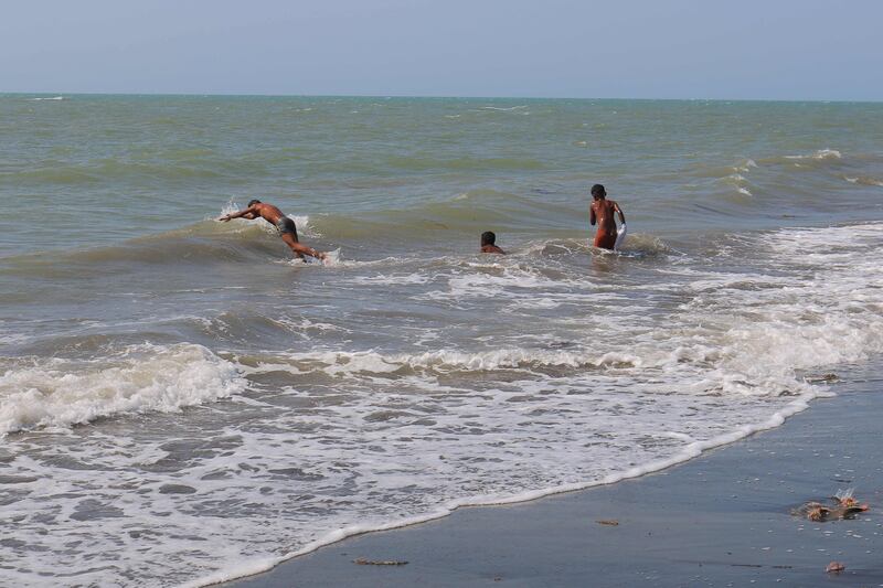 Yemeni children swim in sea at the Red Sea port of Hodeidah on the morning after US and British forces struck rebel-held targets in Yemen. AFP
