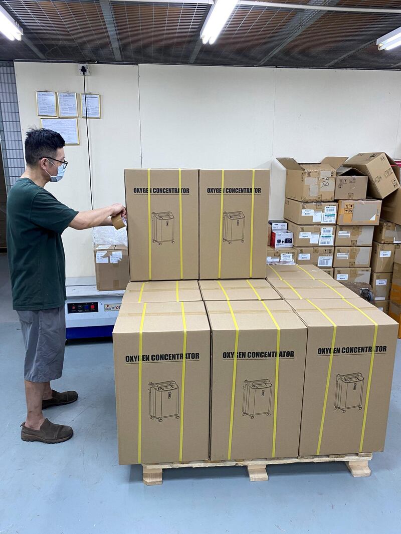 A worker packs oxygen concentrators, a device that extracts oxygen from the air to help Covid-19 patients breathe, in a warehouse in Hong Kong. Shipments of the machines to India has risen as people are forced to rely on home care of patients with hospitals turning away patients. courtesy Jacky’s Electronics