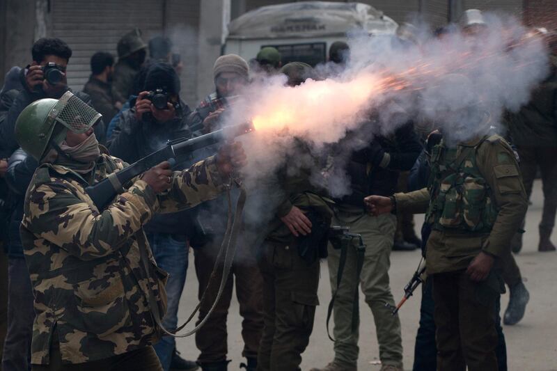 An Indian paramilitary solider fires tear gas shell towards Kashmiri protesters in Srinagar. AP Photo