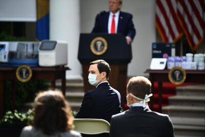 White House Senior Advisor and son-in-law Jared Kushner (C) looks on as US President Donald Trump holds a news conference on the novel coronavirus, COVID-19, in the Rose Garden of the White House in Washington, DC on May 11, 2020. / AFP / Brendan Smialowski
